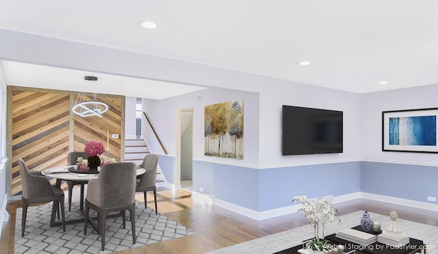 dining space featuring hardwood / wood-style floors and wooden walls