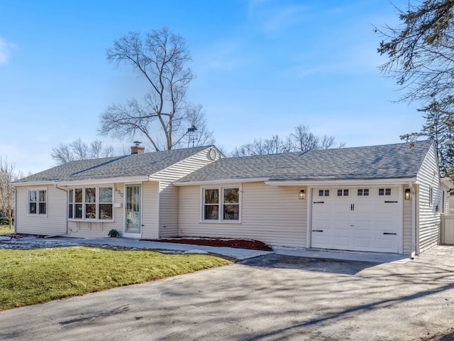 ranch-style home with a garage and a front yard