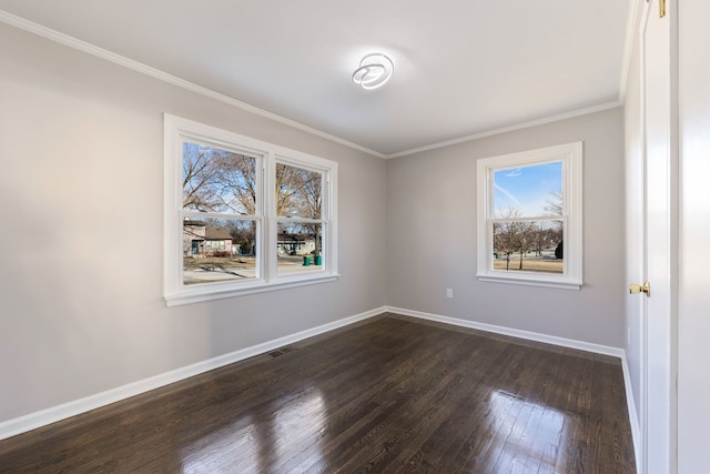 spare room featuring ornamental molding and dark hardwood / wood-style flooring