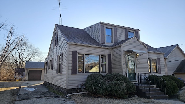 view of front of home with a garage and an outdoor structure