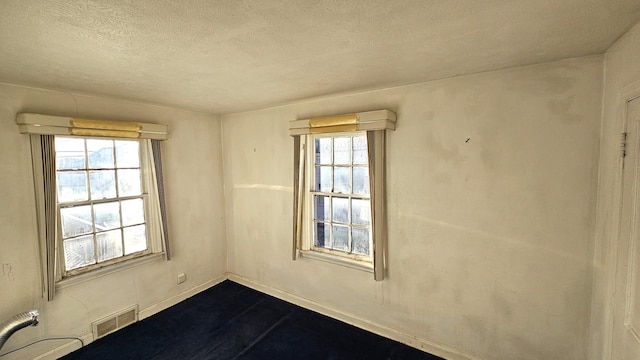 spare room featuring a textured ceiling