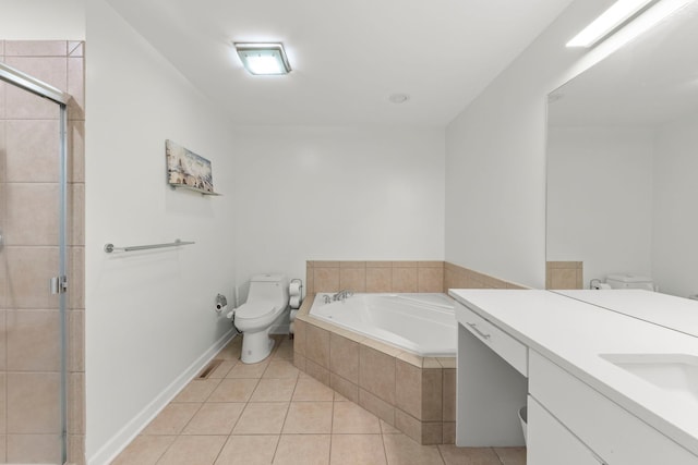 bathroom with a garden tub, tile patterned flooring, toilet, vanity, and tiled shower