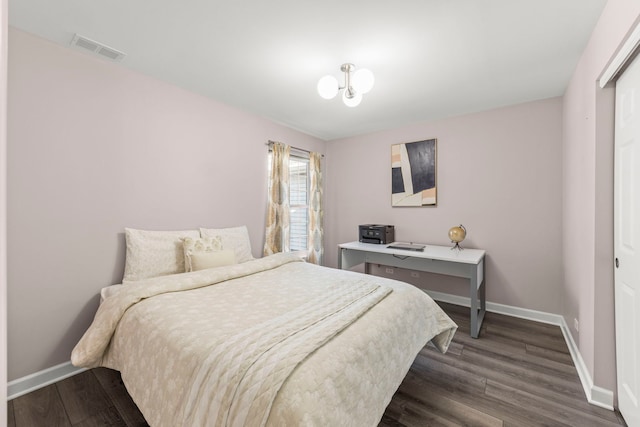 bedroom with dark wood-style floors, baseboards, and visible vents