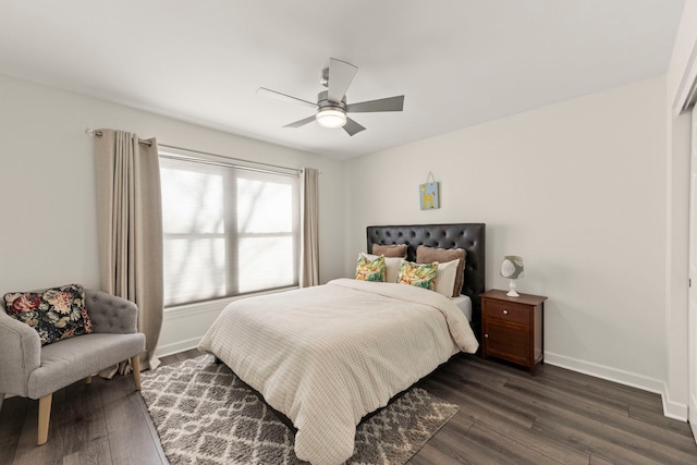 bedroom with dark wood-type flooring, ceiling fan, and baseboards