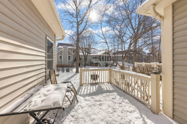 snow covered deck with a residential view