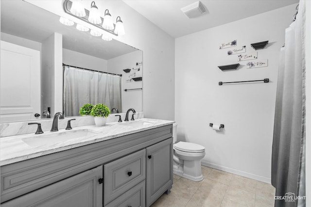 bathroom with tile patterned floors, vanity, and toilet