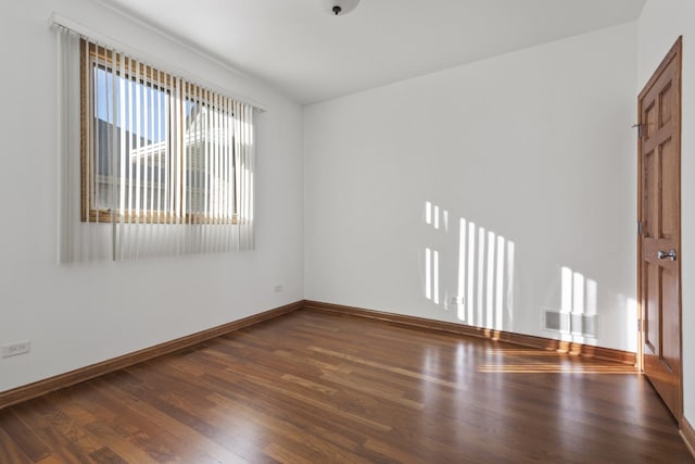 unfurnished room featuring dark hardwood / wood-style floors