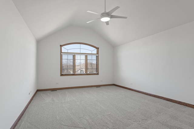 carpeted empty room with lofted ceiling and ceiling fan