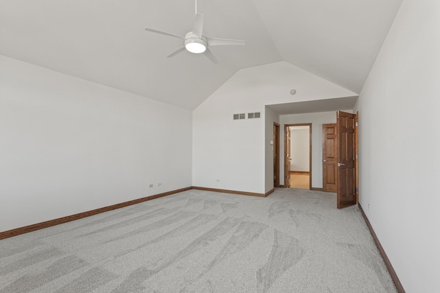 interior space with ceiling fan, vaulted ceiling, and light carpet