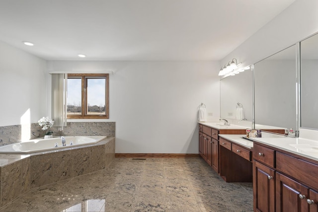 bathroom featuring vanity and a relaxing tiled tub