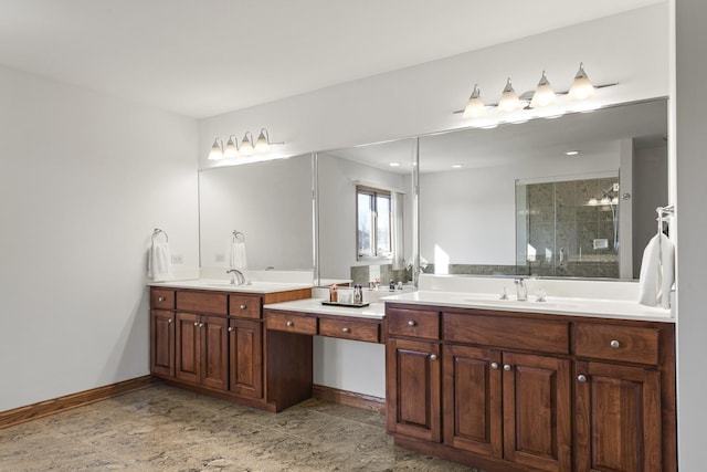 bathroom featuring a shower with door and vanity