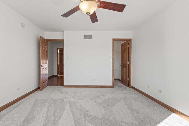 unfurnished bedroom featuring light carpet and ceiling fan