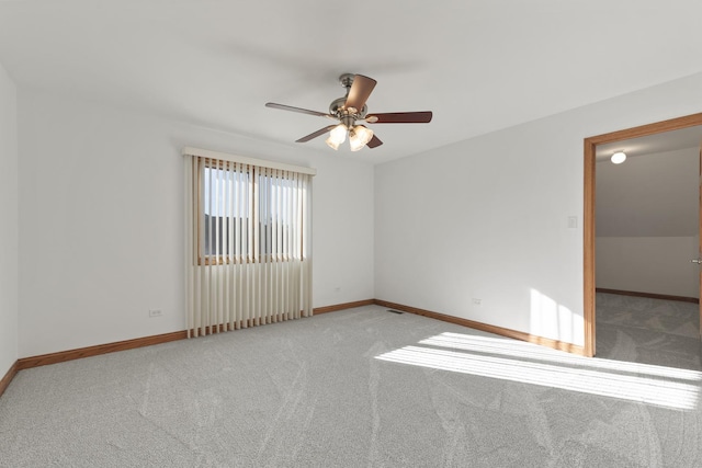 carpeted spare room with ceiling fan