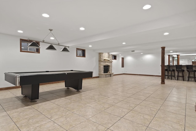 game room featuring light tile patterned floors, pool table, a fireplace, and indoor bar