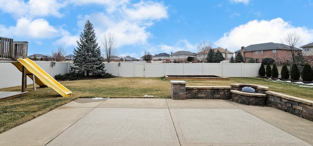 view of yard featuring a playground and a patio