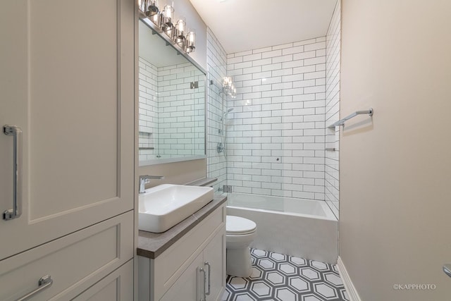 full bathroom featuring tiled shower / bath combo, vanity, tile patterned floors, and toilet