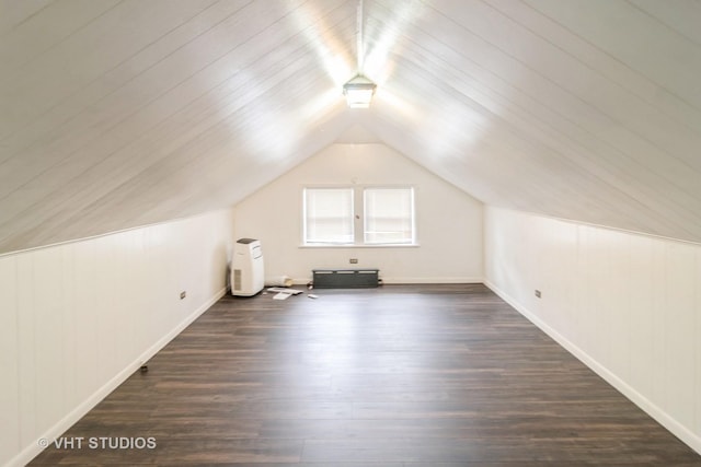 bonus room with vaulted ceiling and dark wood-type flooring