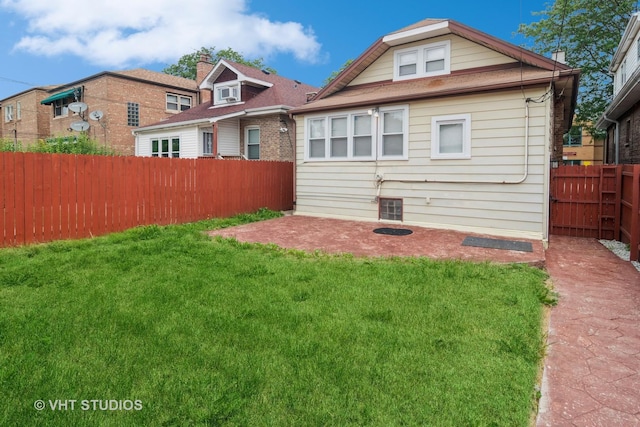 back of property with a patio and a lawn