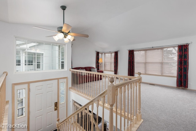 interior space featuring carpet floors, vaulted ceiling, and plenty of natural light