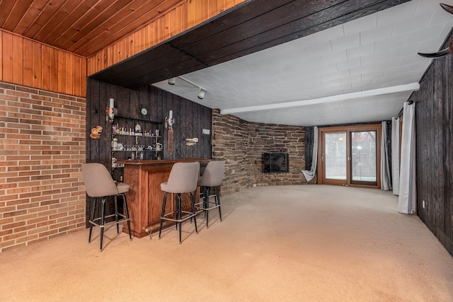 bar with light carpet and wooden walls