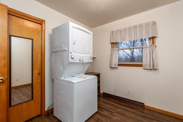 washroom featuring stacked washer / drying machine and dark hardwood / wood-style floors