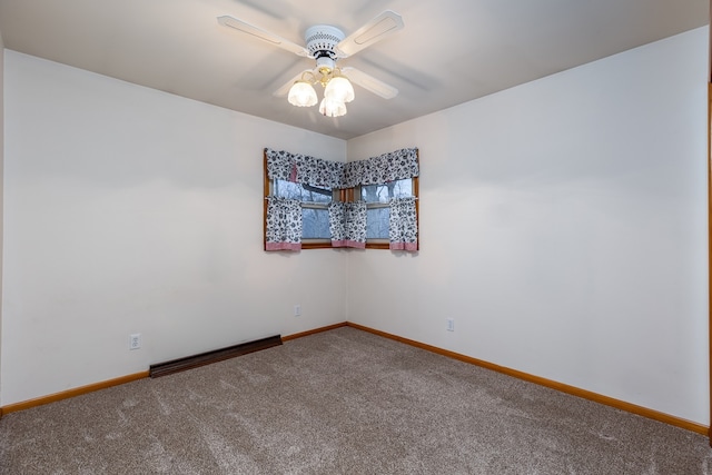 carpeted spare room featuring ceiling fan