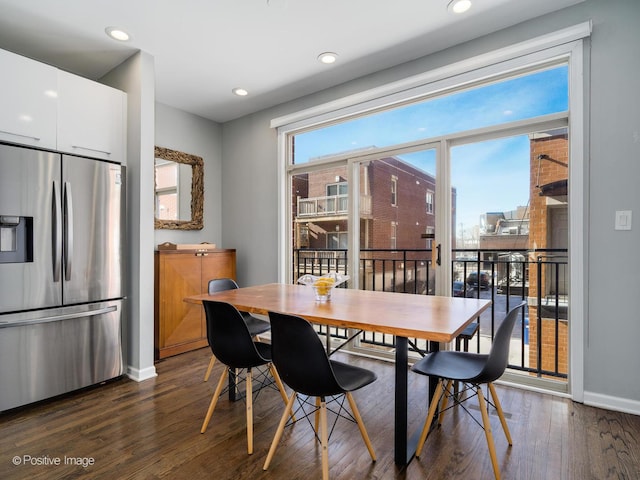 dining room with a healthy amount of sunlight and dark wood-type flooring