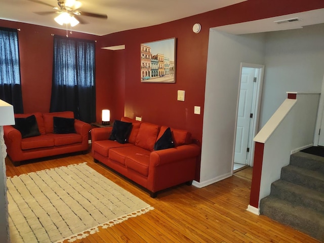 living room featuring ceiling fan and light wood-type flooring