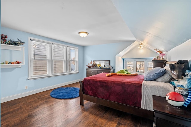 bedroom with wood-type flooring and vaulted ceiling