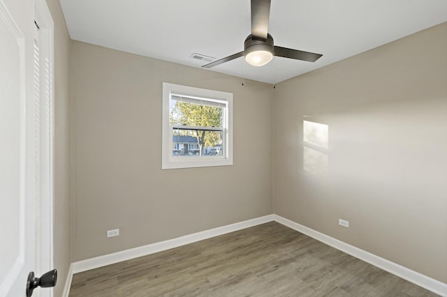 spare room with hardwood / wood-style flooring and ceiling fan