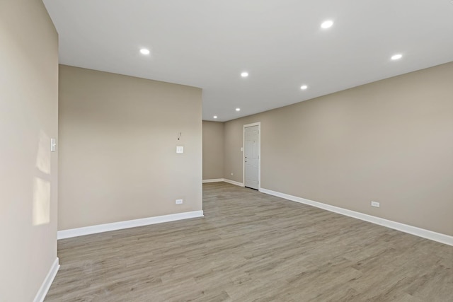 spare room with light hardwood / wood-style flooring