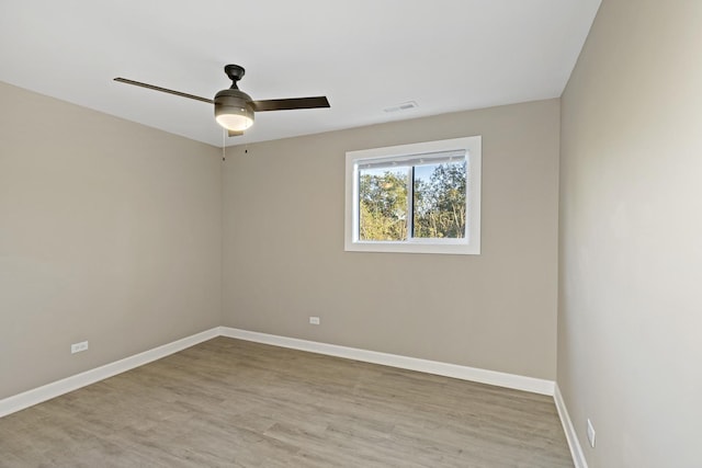 empty room with ceiling fan and light wood-type flooring