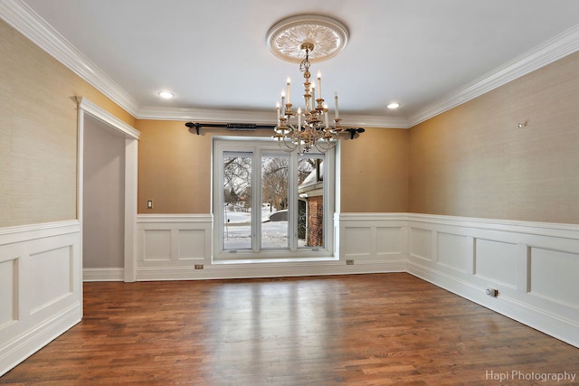 unfurnished dining area featuring dark wood-style floors, ornamental molding, recessed lighting, and an inviting chandelier