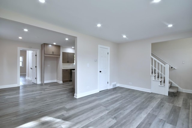 unfurnished living room with dark hardwood / wood-style flooring