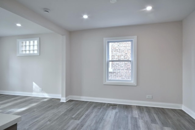 empty room with hardwood / wood-style flooring