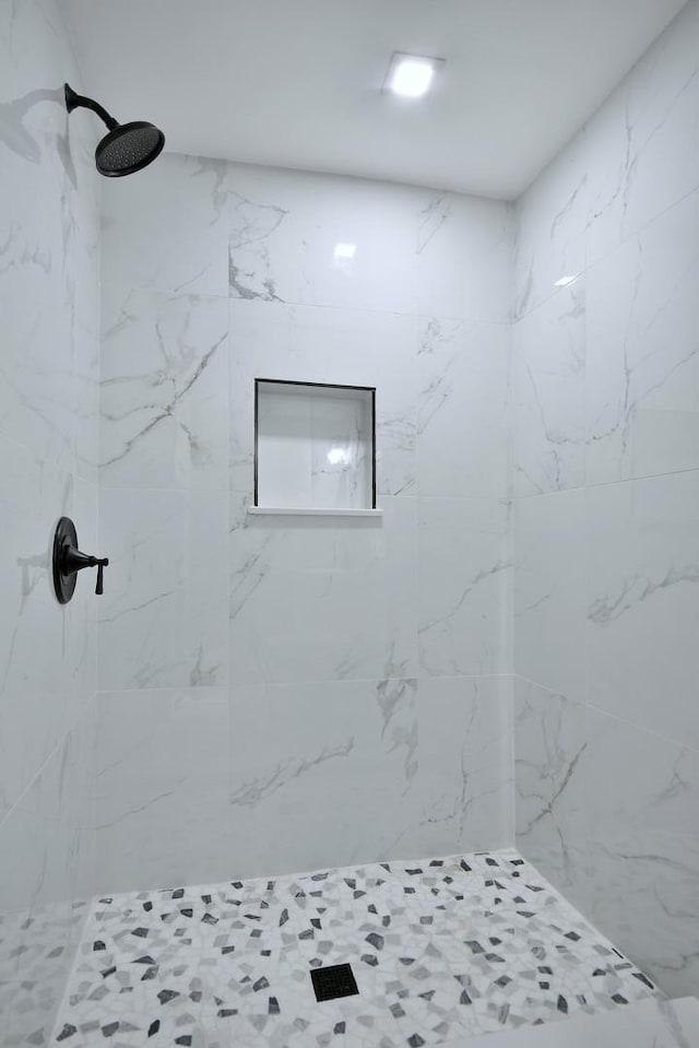 bathroom with tiled shower