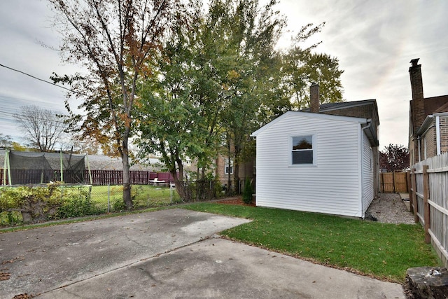 exterior space with a trampoline and a patio area