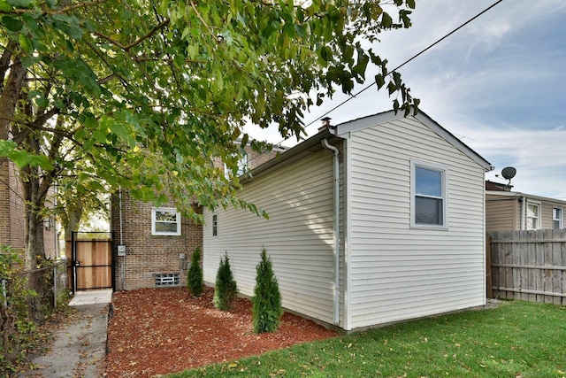 view of property exterior featuring a lawn