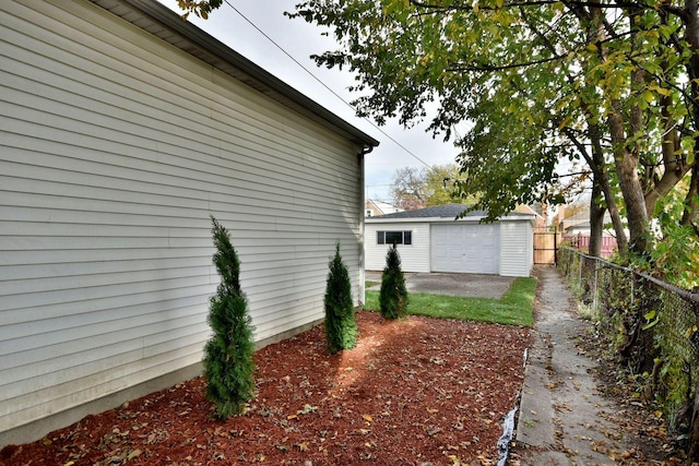 view of property exterior with an outbuilding and a garage