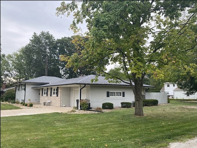 single story home with a garage, concrete driveway, and a front lawn