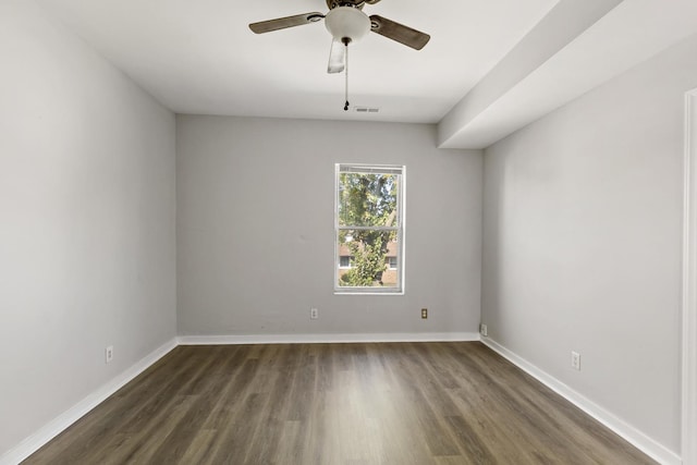 spare room featuring ceiling fan and dark hardwood / wood-style flooring