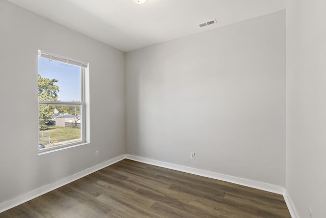 spare room with dark hardwood / wood-style floors and a wealth of natural light