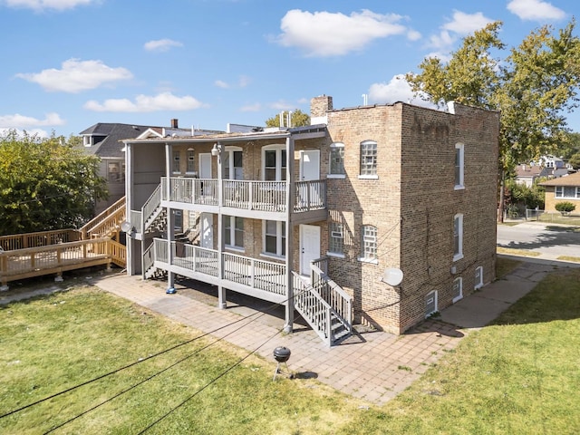 rear view of property with a lawn