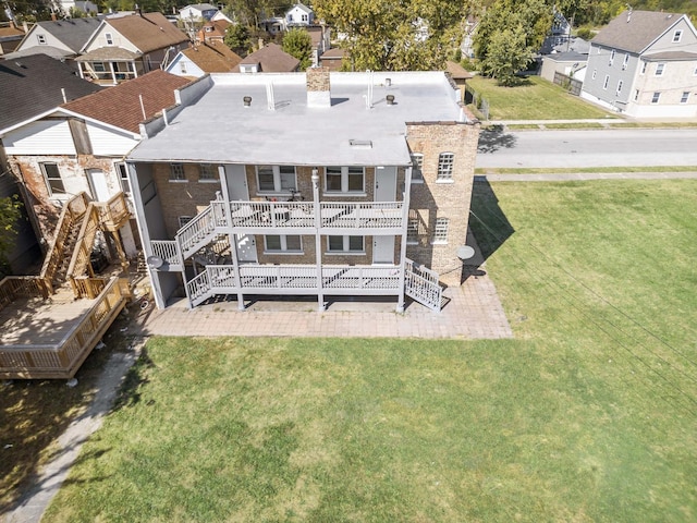 rear view of house with a yard and a deck