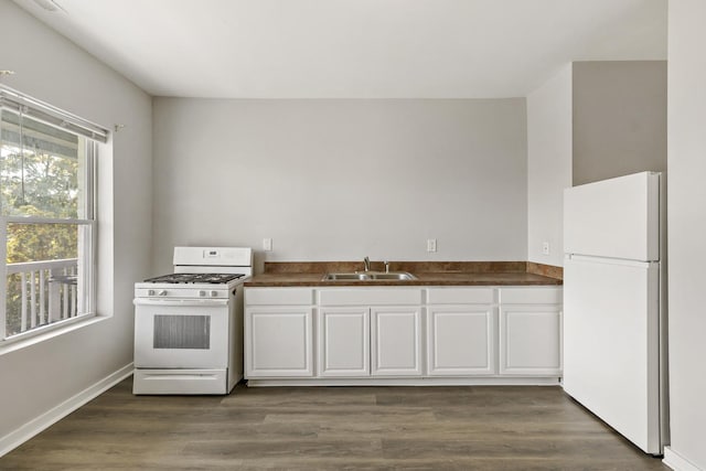 kitchen with white appliances, a healthy amount of sunlight, sink, and white cabinets