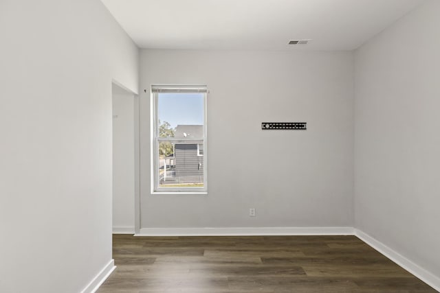 unfurnished room featuring dark hardwood / wood-style flooring