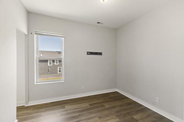 unfurnished room featuring dark hardwood / wood-style floors