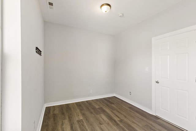 unfurnished room featuring dark wood-type flooring