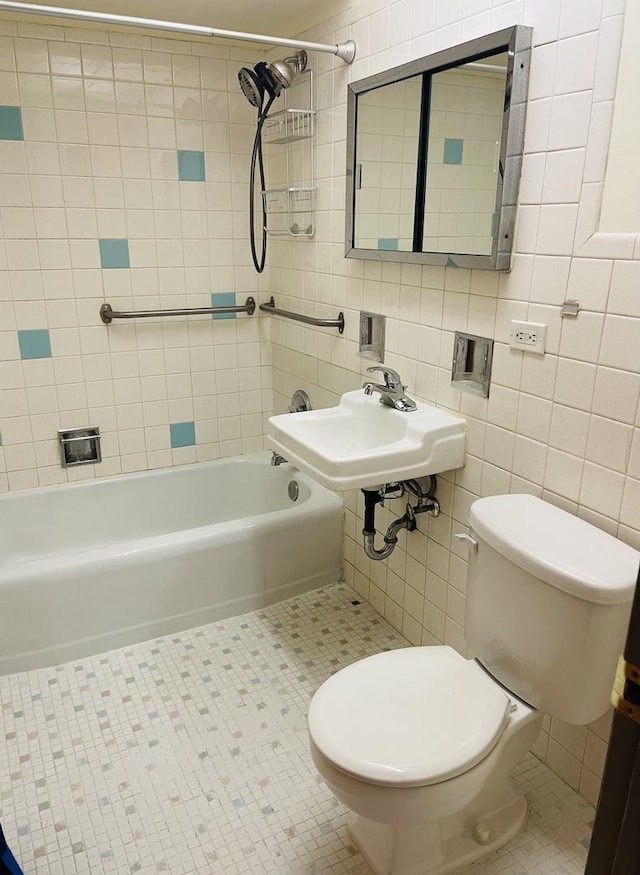 full bathroom with tile patterned flooring, tile walls, and toilet