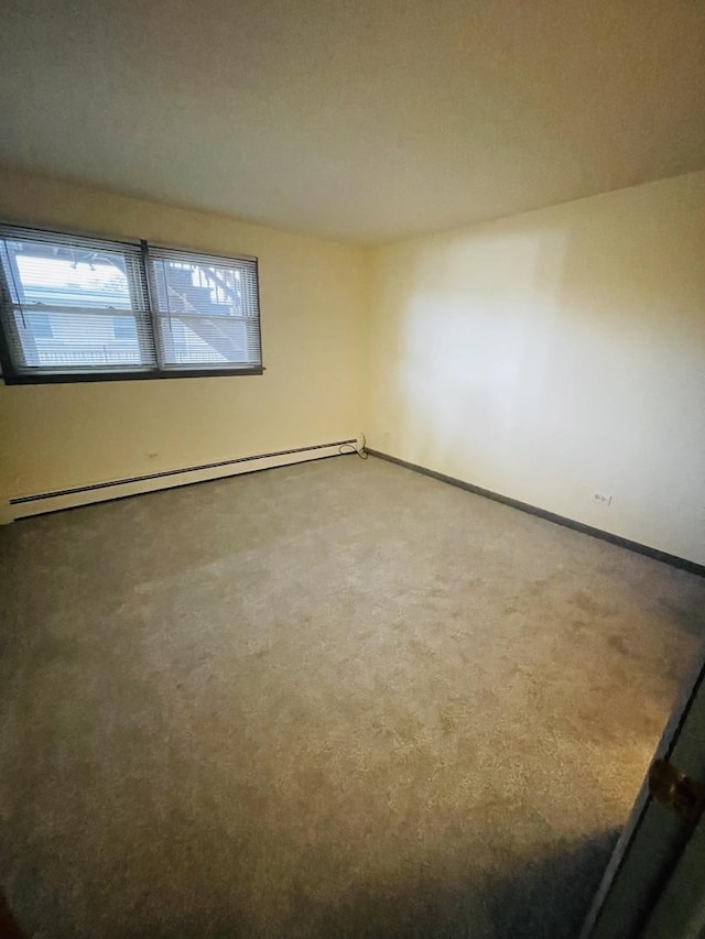 spare room with carpet floors and baseboard heating